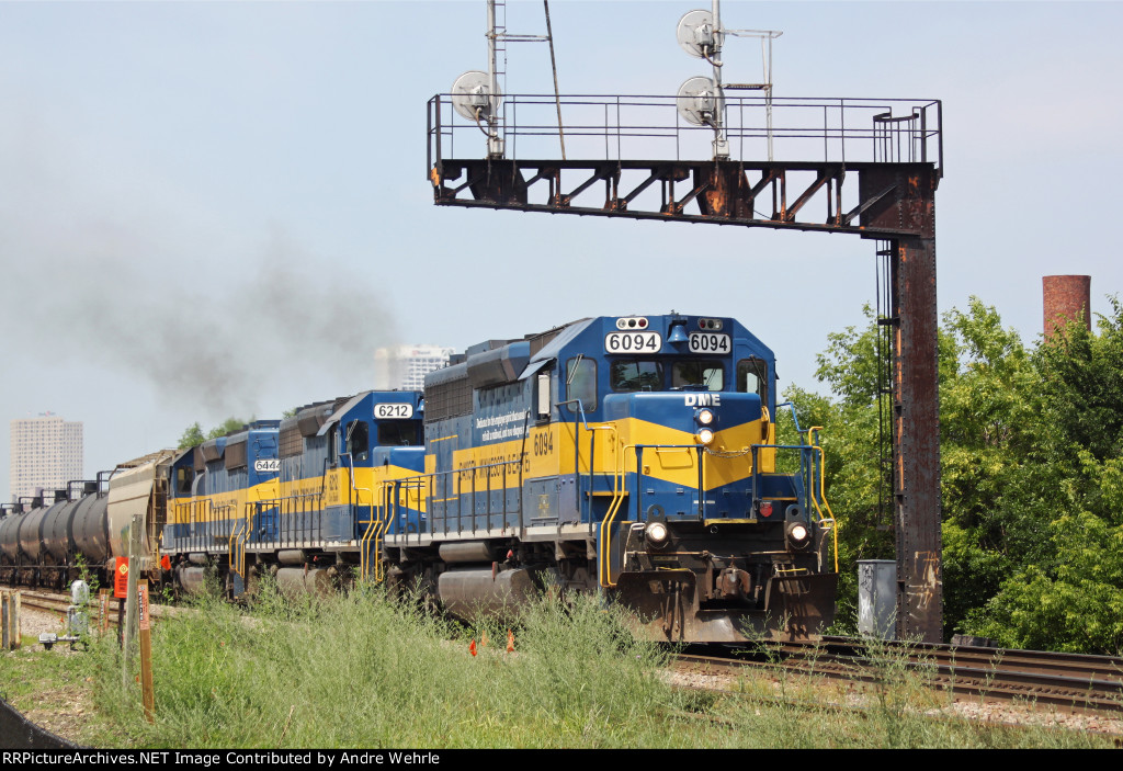 The Maple St. signal bridge frames DME 6094 and its two blue and gold sisters on train 632